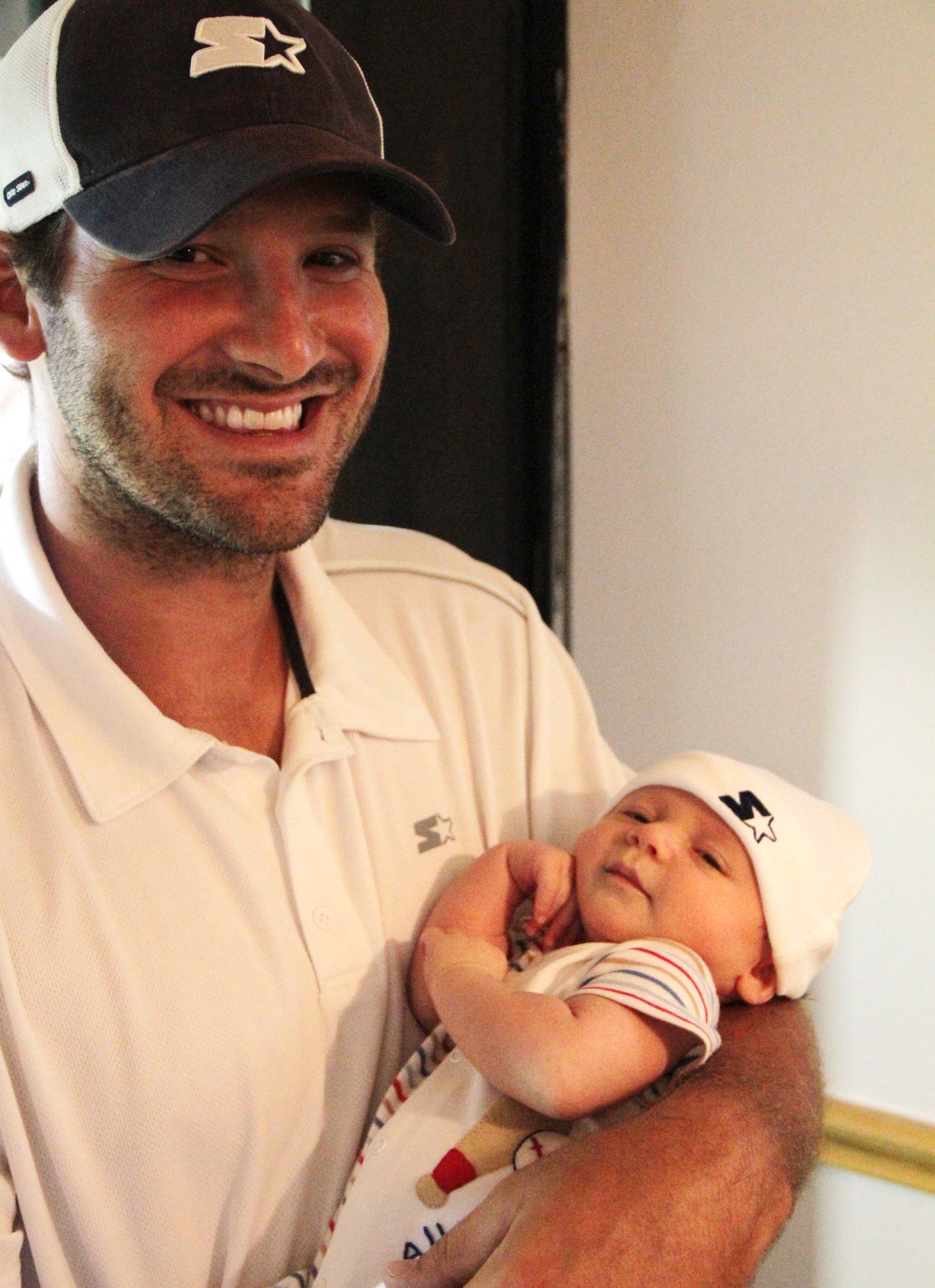 Tony Romo and son Hawkins in Starter gear