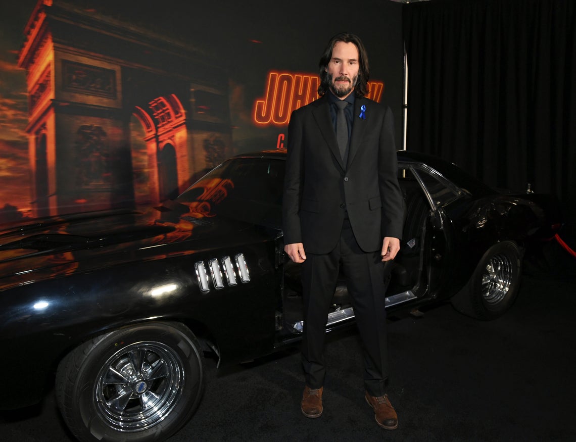Keanu Reeves attends “John Wick: Chapter 4” Los Angeles Premiere at TCL Chinese Theatre on March 20, 2023 in Hollywood, California. Members of the cast all wore royal blue ribbons in honor their late costar, Lance Reddick.