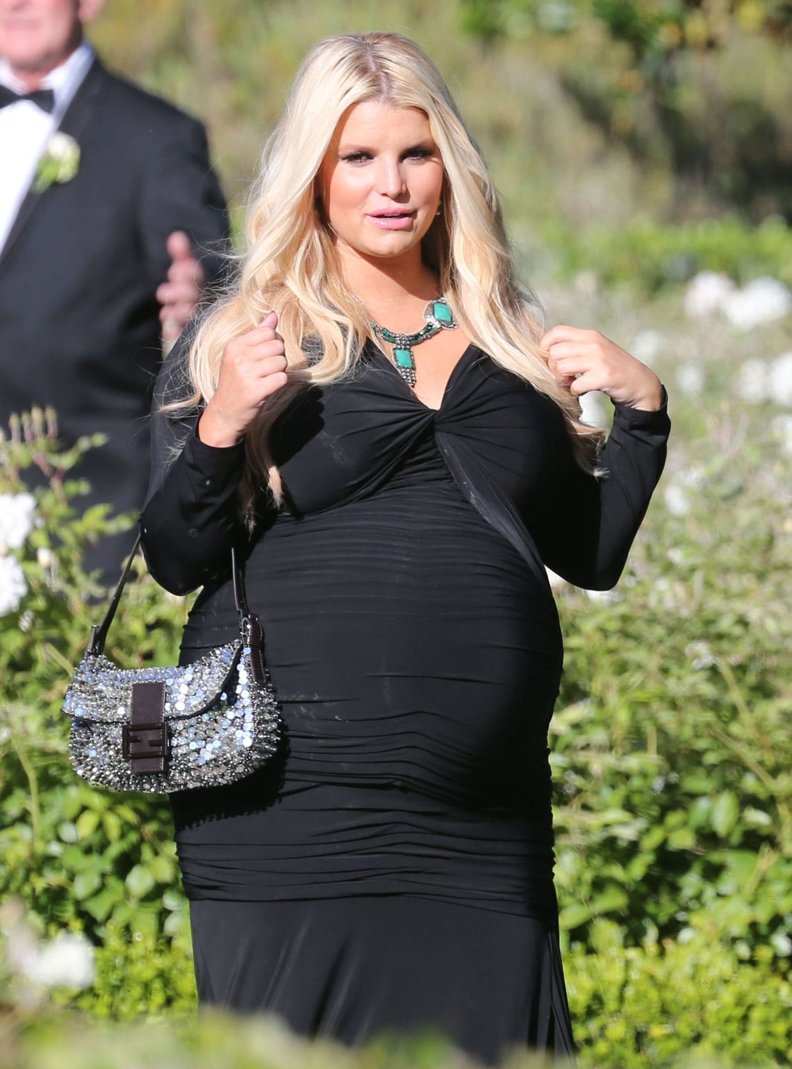Elegant Maternity Style: Jessica Simpson Stuns in a Black Gown at a Wedding