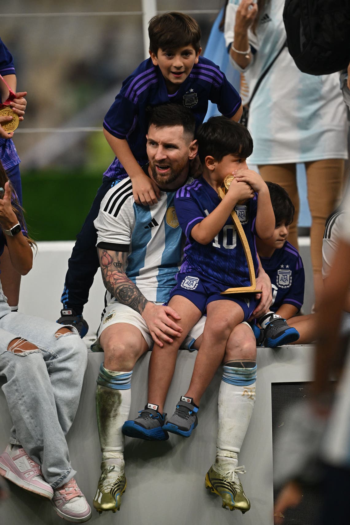 Lionel Messi celebrates with his children Thiago, Ciro and Mateo after Argentina won the Qatar 2022 World Cup final football match between Argentina and France at Lusail Stadium in Lusail, north of Doha on December 18, 2022.